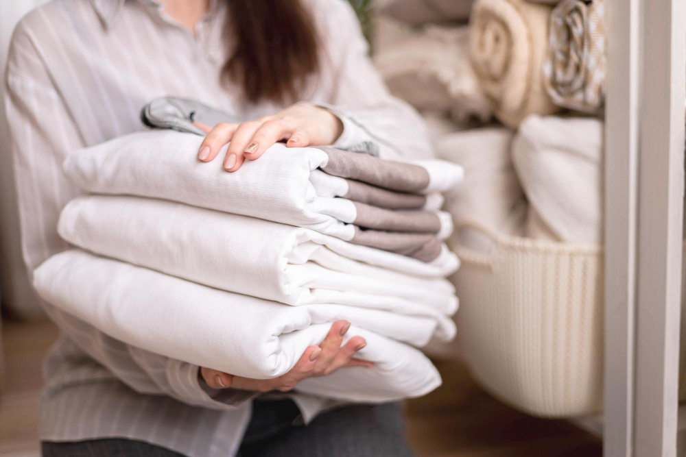 Team member carefully folding laundry